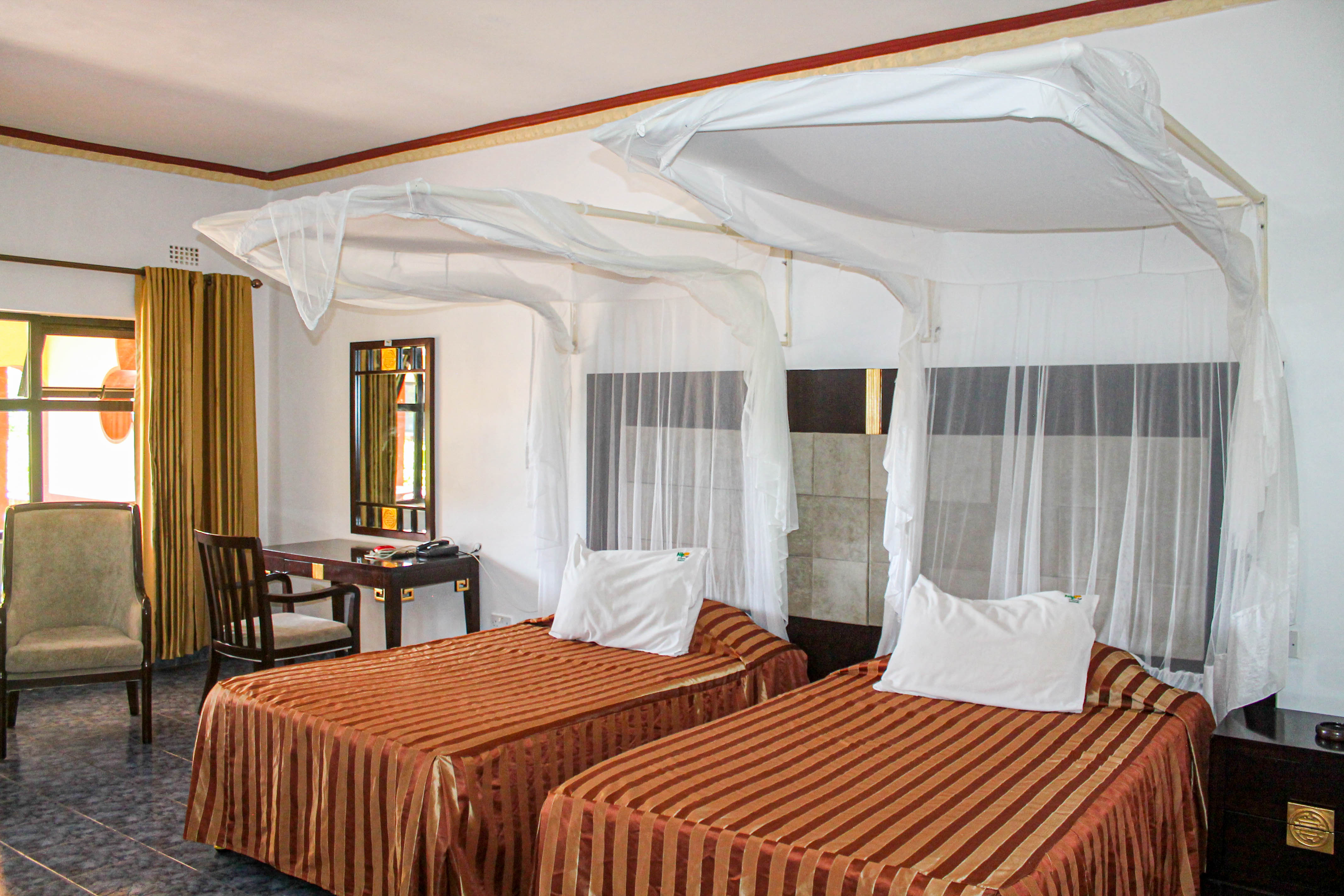 inside view of room with double bed dresser and bathroom in view
